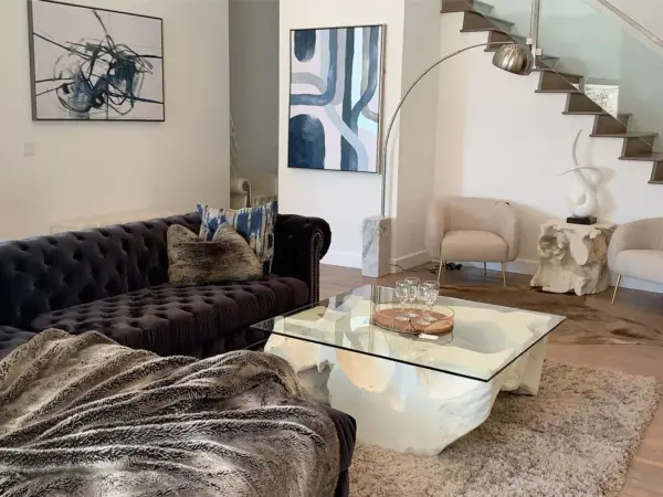 Hill House lounge with sectional sofa and view into open kitchen.