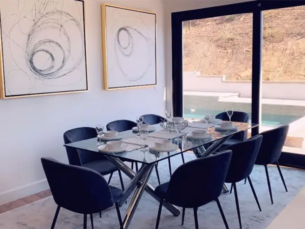 Dinner setting or product placement ready — glass table, scenic window.