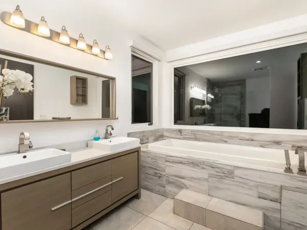 Spa-style master bath with deep tub, glass shower, and double vanity — built for reset and rework.